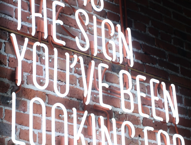 a neon sign that says this is the sign you've been looking for